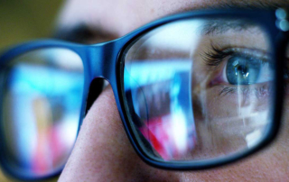 An up close picture of someone wearing glasses