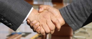 A handshake is pictured