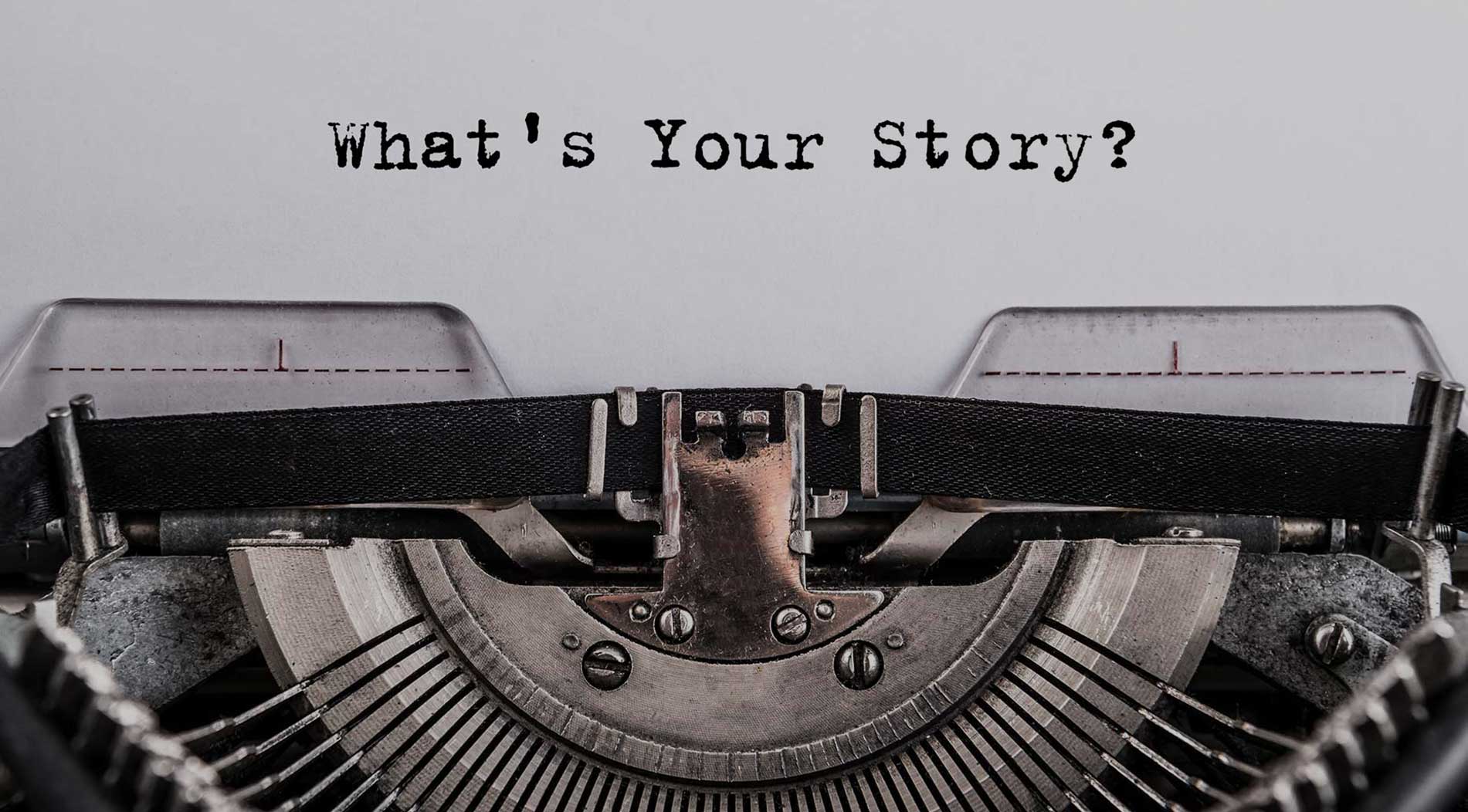 A typewriter has written "What's Your Story?"