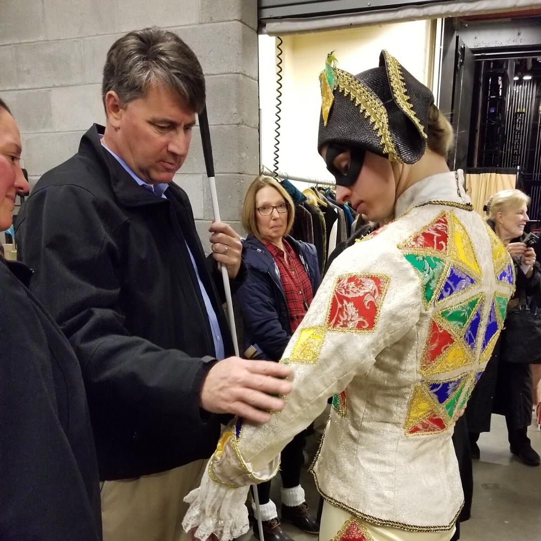 Live Audio Describer attendee feeling a costume during the tactile tour