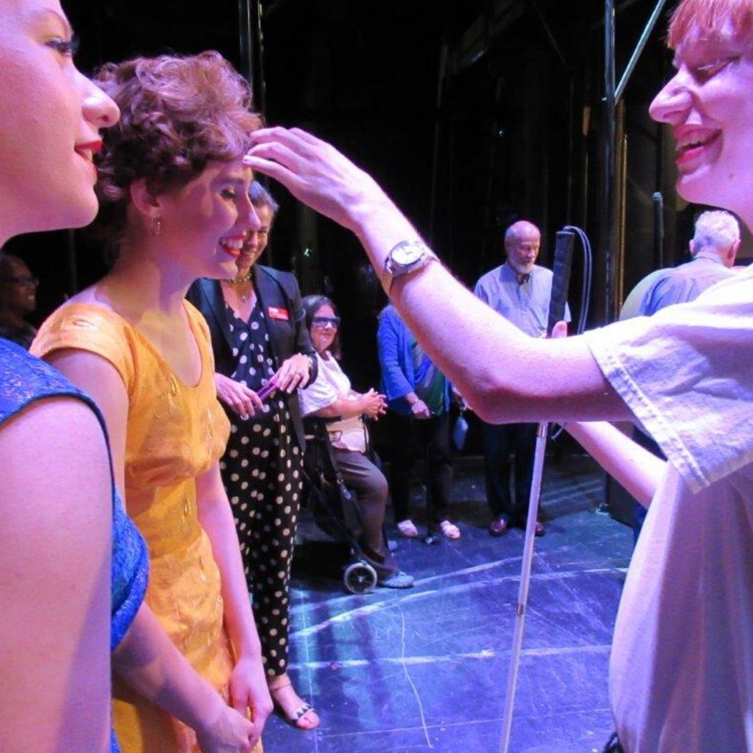 Live Audio Describer attendee touching an actor during the tactile tour