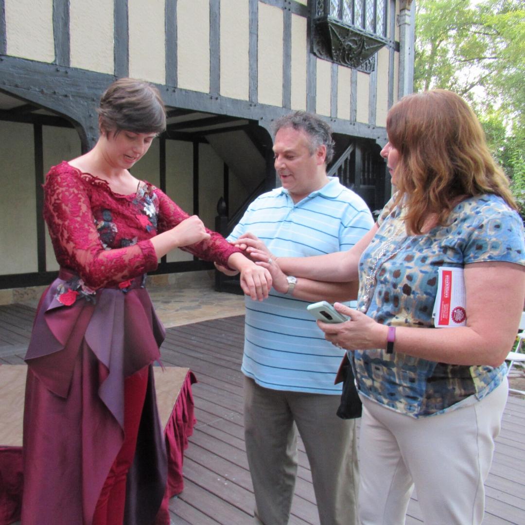 Live Audio Describer attendee touching a costume during the tactile tour